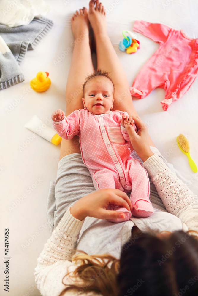 Young mother holding her newborn child Young mother holding her newborn child
