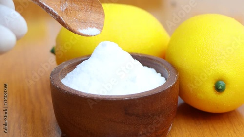 Citric acid white powder, Lemon extract is used as raw material, wood background 