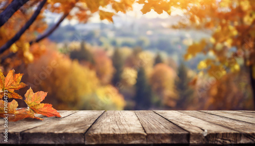 The empty wooden table top with blur background of autumn. 