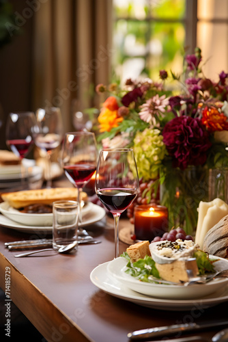 Festive Fine Dining: Intimate Celebratory Dinner Table Setting with Floral Centerpiece and Gourmet Food