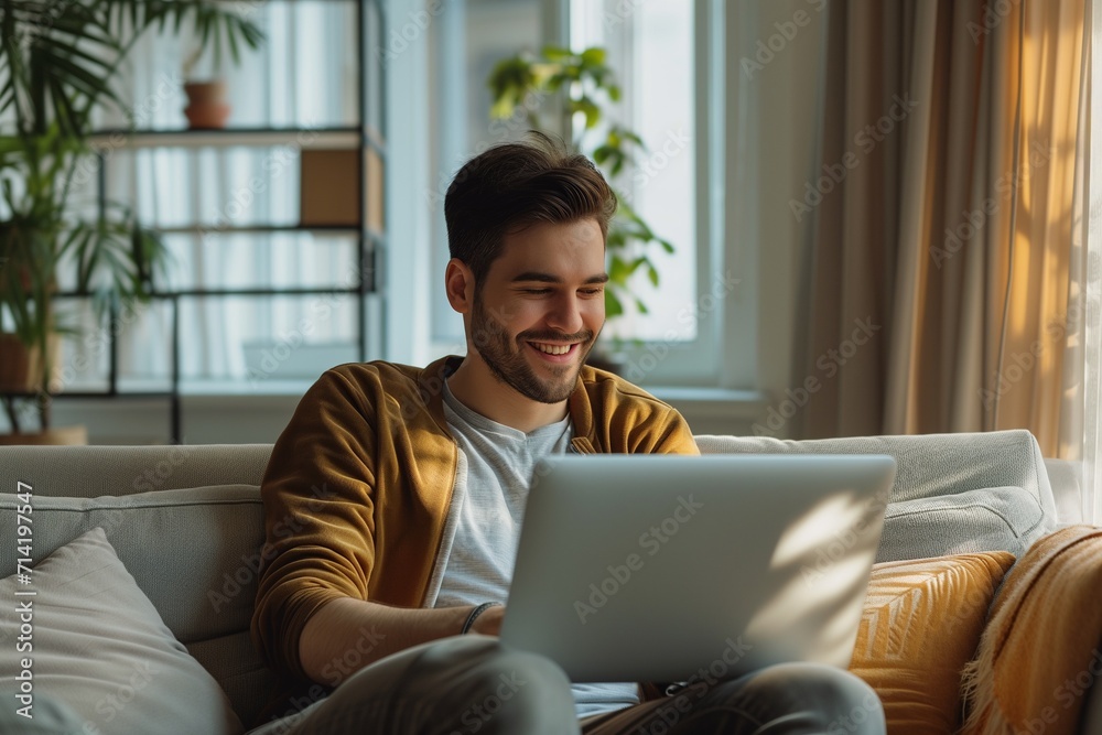 Smiling Man Using Laptop in Cozy Living Room