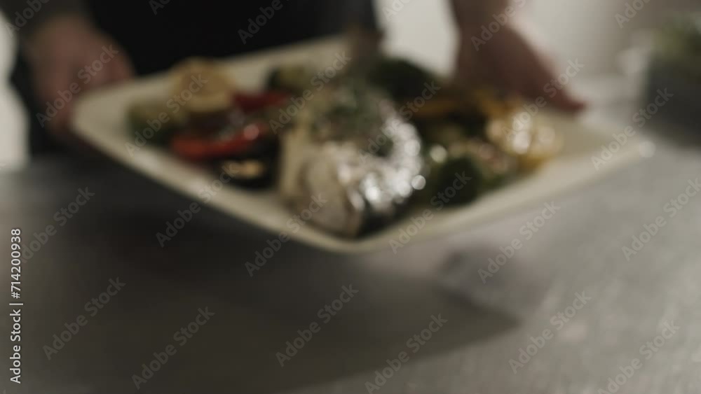 Person Holding a Plate of Food on a Table Person Holding a Plate of Food on a Table