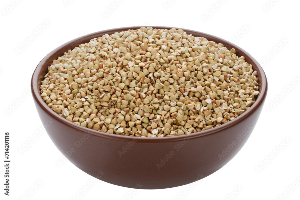 Unroasted buckwheat in a bowl. Isolated on a white background. Unroasted buckwheat in a bowl. Isolated on a white background.