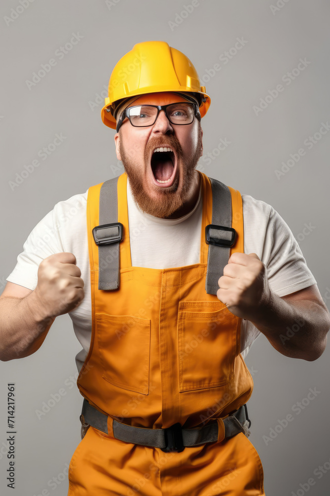 Photo of a worker man with a helmet rejoicing by saying hurray Photo of a worker man with a helmet rejoicing by saying hurray