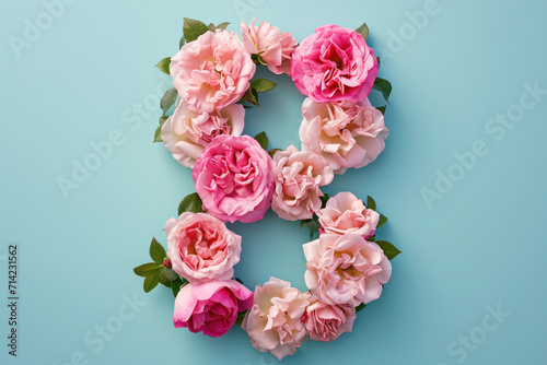 Number 8 shape from pink flowers on blue background. Concept of Woman's day 8 march.