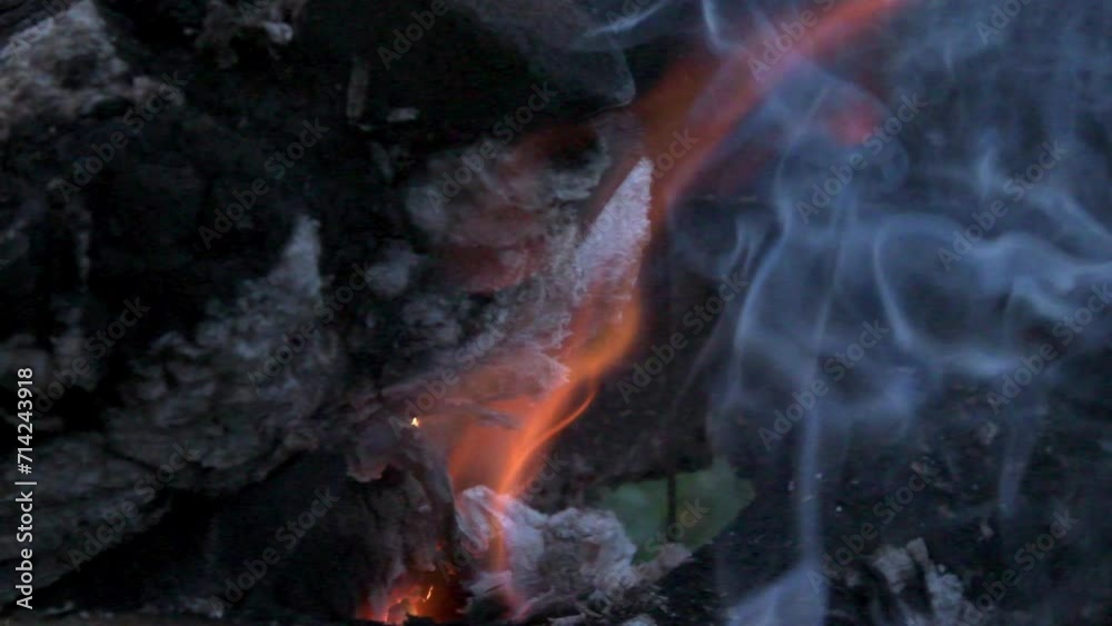 wooden logs burning in campfire at evening outdoor. close up wooden logs burning in campfire at evening outdoor. close up