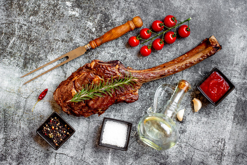 Grilled Tomahawk steak on stone background 