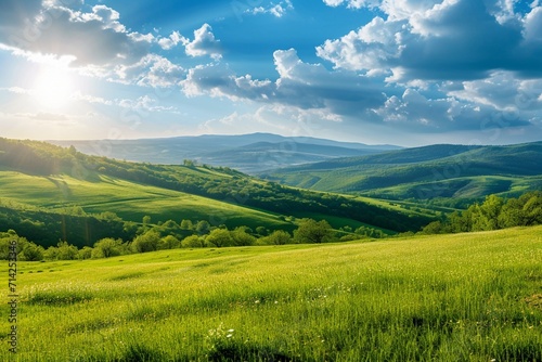 panorama of beautiful countryside of romania. sunny afternoon. wonderful springtime landscape in mountains. grassy field and rolling hills. rural scenery