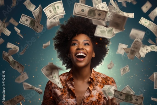 Portrait of a Smiling and excited African woman holding lots of money. photo