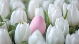 a pink egg in a field of white tulips