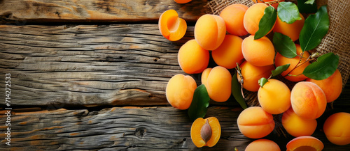 Ripe apricots bask on rustic wood, a sun-kissed bounty heralding the sweetness of summer photo