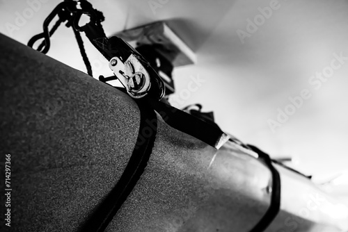 Selective focus on the side of a kayak that has used a Hoist and pulley system to store on the ceiling of a garage. photo