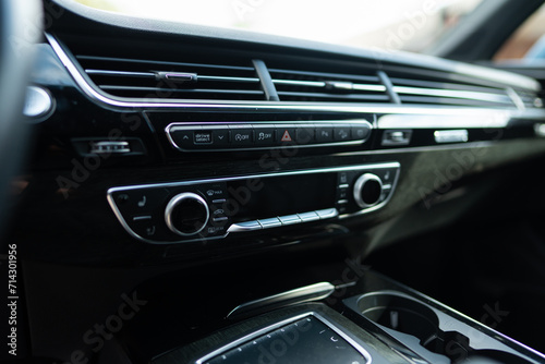 Car air conditioning system maintaining cool interior environment in hot weather. AC adjusting cabin temperature and fan speed inside expensive car models