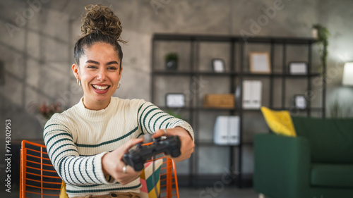 One young woman hold joystick play console video game at home