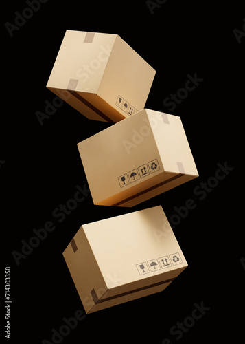 Set of falling beige cardboard boxes for delivery of goods isolated on a black background. Recyclable packaging. Mockup. 3d render