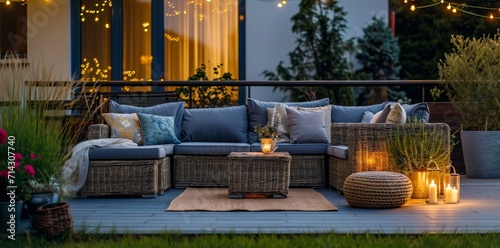 an outdoor balcony with lighting, couches and small gardens