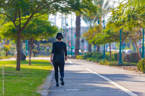 Girl in sportswear walking in the park