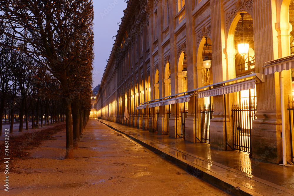 The wall of arches, columns and arcades bordering the Royal Palace Garden at rainy night. Paris. France. The wall of arches, columns and arcades bordering the Royal Palace Garden at rainy night. Paris. France.