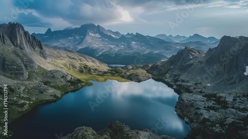  a lake in the middle of a mountain range with a mountain range in the background and a lake in the middle of the mountain range in the middle of the foreground.