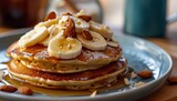 a plate of pancakes with bananas and almonds