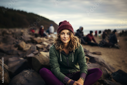 Portrait of a woman on a rocky sea shore at sunset.