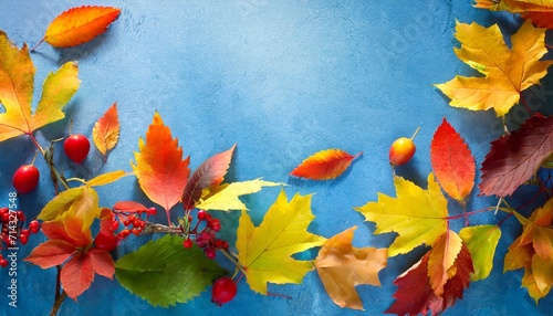 autumn background with colored leaves on blue background 