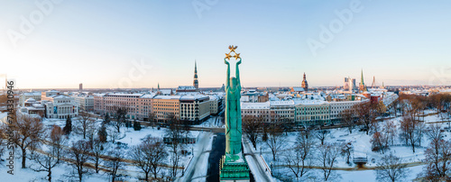 Beautiful sunrise panorama over Riga by the statue of liberty - Milda in Latvia. The monument of freedom.
