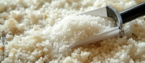 A detailed photo of salt with a plastic scoop in Guerande, France. photo