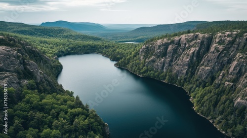  a large body of water surrounded by lush green trees and a mountain range on the other side of the lake in the middle of the picture is a forested area.
