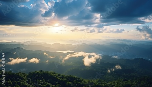 View of the sea of clouds from the top of the mountain peak. Tropical green forest, falling leaves with the vibrant morning reflection of the sunrise. © Virgo Studio Maple