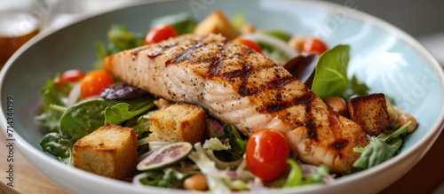 Grilled fish, croutons, and cherry tomatoes added to salmon Caesar salad.