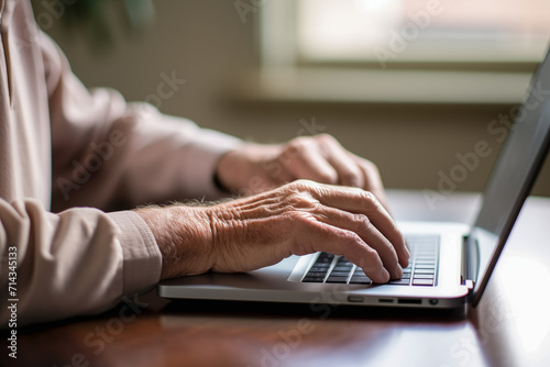 senior citizen typing on a laptop keyboard for concept offinancial crime, scamming seniors through the internet