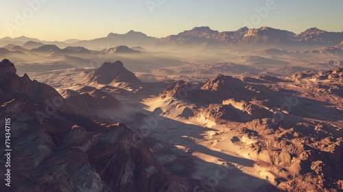  an aerial view of a mountain range in the middle of the desert, with the sun shining on the mountain tops and the mountains in the distance, in the foreground.