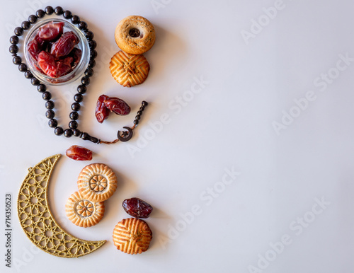 Variety of semolina maamoul cookies displayed with crescent ,star and Ramadan decorations. Traditional Arabic sweets for Eid al Adha and Eid al Fitr celebrations.