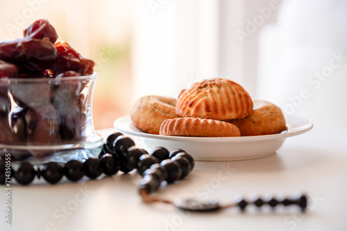 Variety of semolina maamoul cookies displayed with crescent ,star and Ramadan decorations. Traditional Arabic sweets for Eid al Adha and Eid al Fitr celebrations. photo