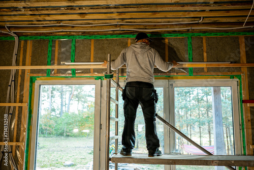 фотографія Skilled worker installing windows in a new construction with exposed insulation