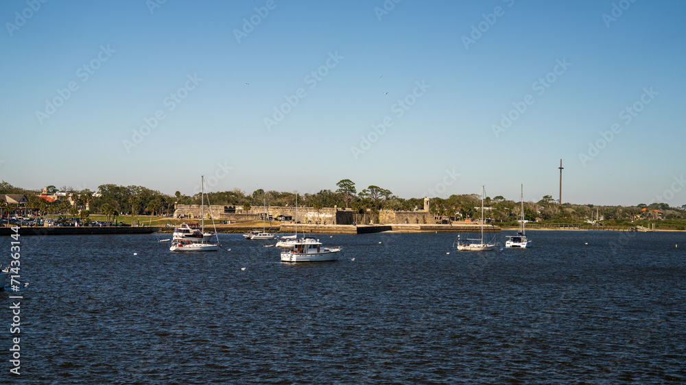 Sailboats anchored in the Matanzas River with a clear blue sky in St Augustine, FL.