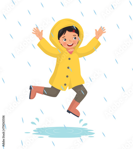 Cute little girl wears raincoat playing jumping  in the rain