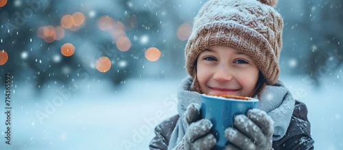 Charming youth enjoying warm drink in winter.