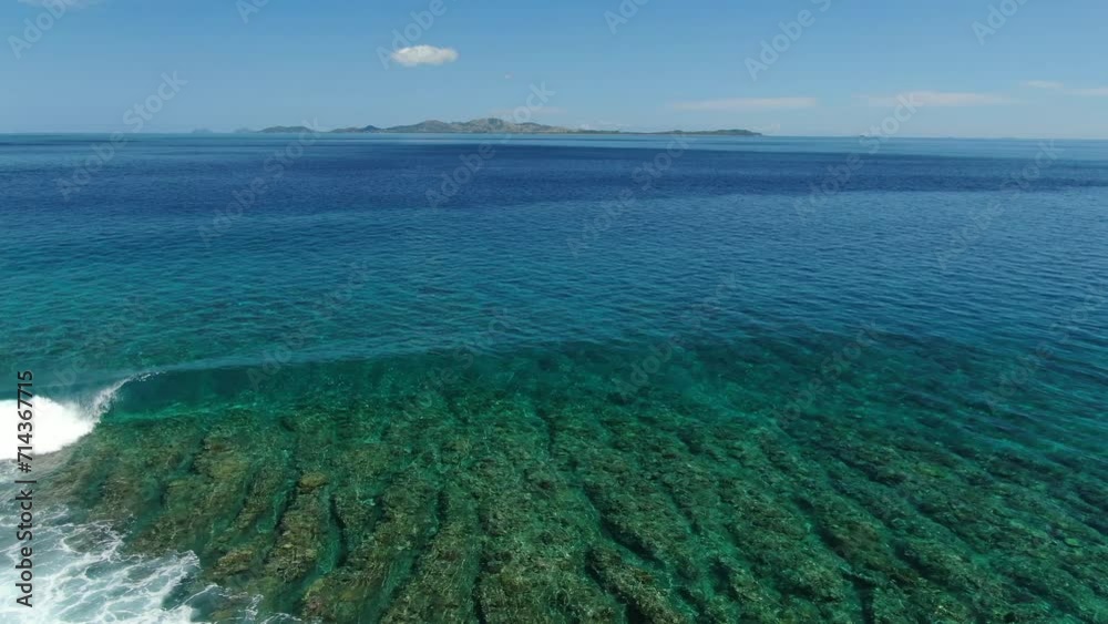 wave breaking over crystal clear shallow reef wave breaking over crystal clear shallow reef