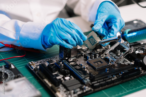 The technician repairing the motherboard in the lab with copy space. the concept of computer hardware, mobile phone, electronic, repairing, upgrade .