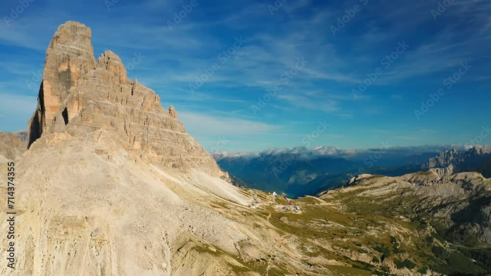 The image showcases the breathtaking Italian Alps Tre Cime di Lavaredo mountain range from above, against a vivid blue sky. The image showcases the breathtaking Italian Alps Tre Cime di Lavaredo mountain range from above, against a vivid blue sky.