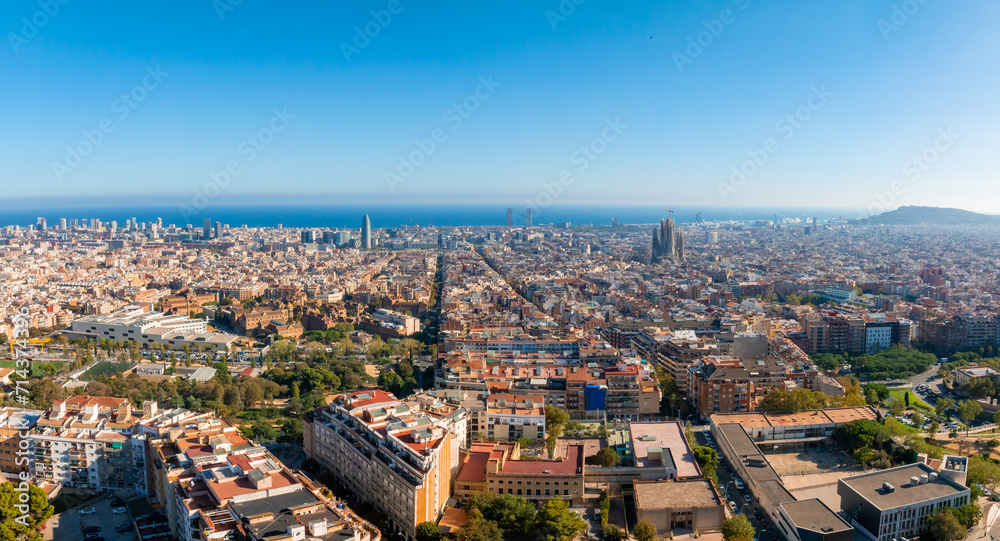 Aerial view of Barcelona City Skyline at sunset. Residential famous urban grid of Catalonia. Beautiful panorama of Barcelona.
