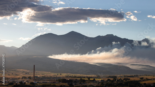 Landscape view of smoke drifting at sunset from control burn in Salida Colorado United States