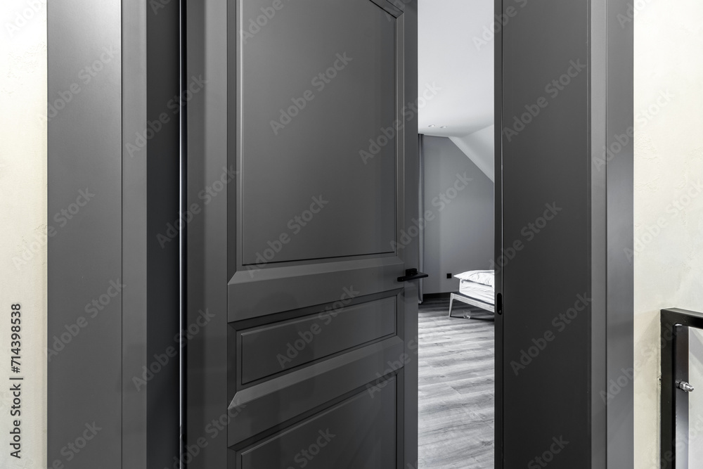 A black interior door ajar in a private house A black interior door ajar in a private house
