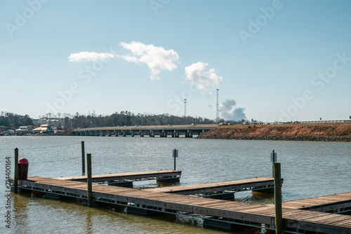 A boat dock in the foreground looking over Lake Wylie, South Carolina with the steam from a nuclear power plant in the background.