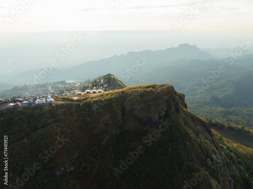 Sunset view at a mountain peak with an overlook parking area, providing visitors with a breathtaking panoramic view of the valley below.