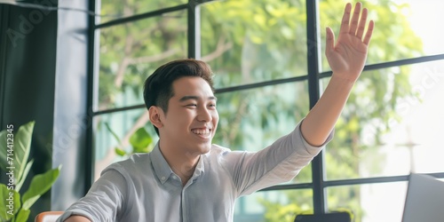 cheerful Asian startup founder celebrating funding success with a joyful high-five and excitement  © StockWorld