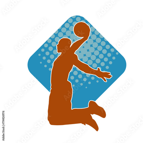 Silhouette of a basket ball player in action pose. Silhouette of a male basket ball athlete.