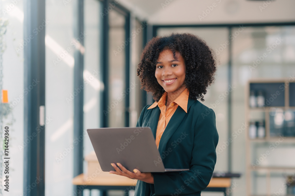 Confident Businesswoman with Laptop in Modern Office. Confident Businesswoman with Laptop in Modern Office.